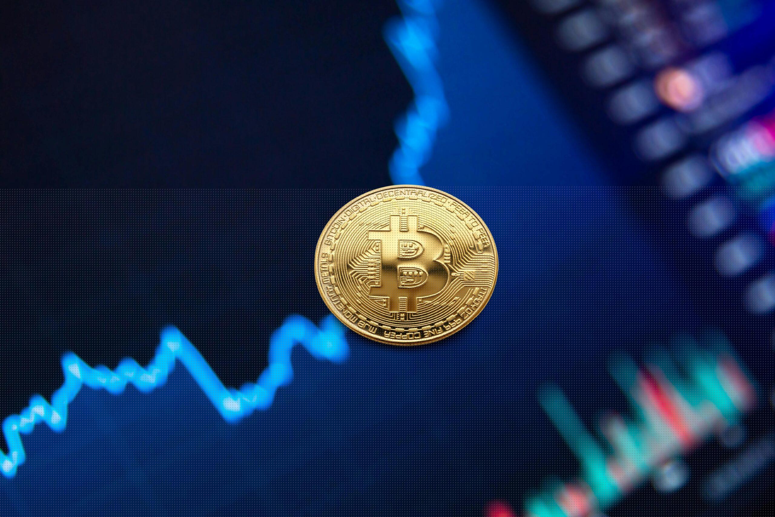 A gold Bitcoin coin against a backdrop of a digital financial chart, symbolizing cryptocurrency trading.